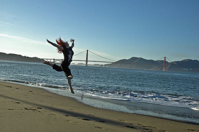 Woman Leaping in the Air at the Beach